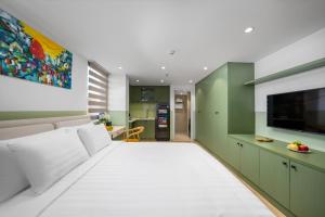 a living room with a white couch and a flat screen tv at Little Charm Boutique Hotel in Hanoi