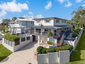 an aerial view of a large white house at 15 Derby Road Moffat Beach in Caloundra