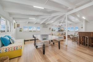 a living room with a table and a couch at 15 Derby Road Moffat Beach in Caloundra