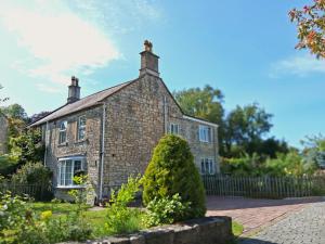 an old brick house with a fence in front of it at Crooked Well in Bath