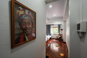 a hallway with a painting of a woman on the wall at BlueHome Vientiane in Vientiane