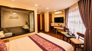 a hotel room with a bed and a bathroom at Lavender SaPa Hotel & Spa Right in the center of Sa Pa - Free foot soak service in Lao Cai