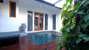a swimming pool in the middle of a house at Villa Sarn 1 Sanur in Sanur +4 photos