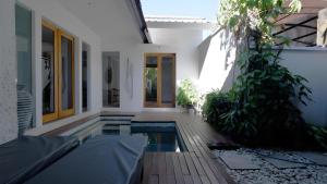 an external view of a house with a swimming pool at Villa Sarn 1 Sanur in Sanur