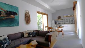 a living room with a couch and a table at Villa Sarn 1 Sanur in Sanur