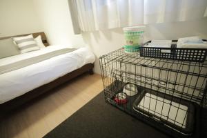 a room with a bed and a wire cage with a basket at Casa Stella 10 by Liaison カーサステラ10 by リエゾン in Osaka