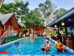 a group of people sitting in a swimming pool at Retreat Bungalow in Phong Nha +35 photos