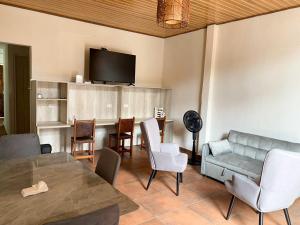 a living room with a couch and a table and chairs at La Villa Study & Relax Apartment in Los Santos