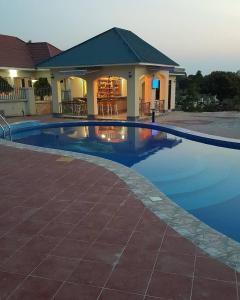 a swimming pool in front of a house at The Lahe Hotels in Mwanza