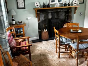 a dining room with a table and a fireplace at Strathnoon in Inverness