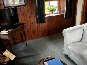 a living room with a couch and a television at Strathnoon in Inverness