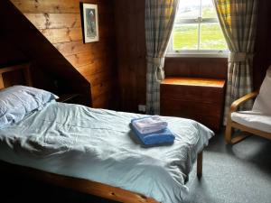 a bedroom with a bed with a blue box on it at Strathnoon in Inverness