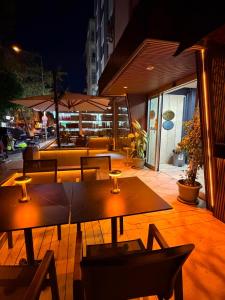 a patio with tables and chairs on a building at Hotel Güleryüz 2 in Antalya +23 photos