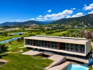 a building with a view of a river and mountains at Green Valley Las Margas Golf in Latas