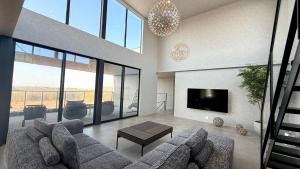 a living room with a couch and a tv at CIN Garden Terrace in Futtsu