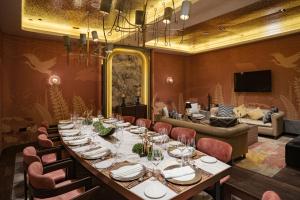 a long dining room with a long table and chairs at Naumi Hotel Singapore in Singapore
