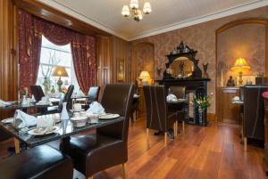 a dining room with a table and chairs and a mirror at Brooklands 5 Star Guest House in Penrith