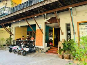 a group of motorcycles parked outside of a restaurant at BlueHome Vientiane in Vientiane