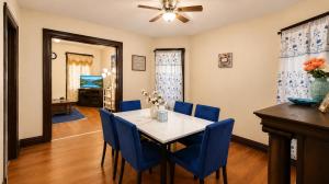 a dining room with a table and blue chairs at Charming 3 Bdr Home 8 mins from the Falls in Niagara Falls