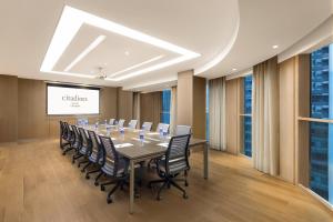 a conference room with a long table and chairs at Citadines South Chengdu in Chengdu