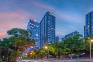 a group of tall buildings in a city at night at Citadines South Chengdu in Chengdu