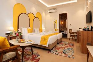 a hotel room with a bed and a table at Kadamb Kuteer Hotel and Resort in Chhatikara