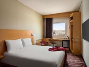 a hotel room with a bed and a desk at ibis Muscat in Muscat +58 photos