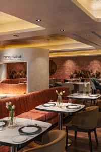 a restaurant with tables and chairs and a bar at Naumi Hotel Singapore in Singapore +15 photos