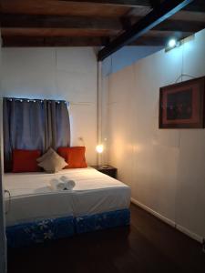 a bedroom with a bed in a room with a lamp at Grace Homestay in Somosomo
