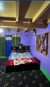 a bedroom with a bed in a purple room at A Sappers Dream House Markoot Gurez in Gurais
