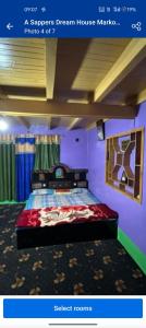 a bedroom with a bed in a purple room at A Sappers Dream House Markoot Gurez in Gurais