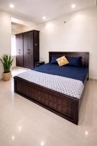 a bedroom with a large wooden bed in a room at Indigo Homes Kondapur in Hyderabad