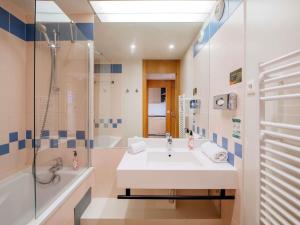 a bathroom with a sink and a shower at Aparthotel Adagio Paris XV in Paris