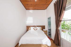 a bedroom with a bed and a window at Minh Đức Villa in Da Lat +146 photos