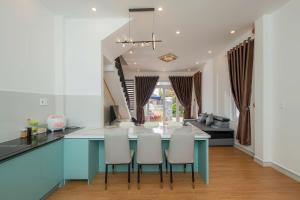 a kitchen and living room with a blue counter and chairs at Minh Đức Villa in Da Lat