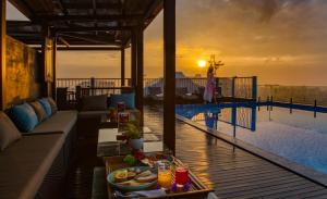 a resort with a pool and a table with a tray of food at Savvy in Hoi An - The Essence of Refined Retreat in Hoi An