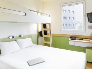 a bedroom with a bunk bed with a laptop on it at Ibis Budget Oviedo in Oviedo