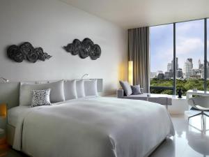 a white bedroom with a large bed and a large window at SO/ Bangkok in Bangkok +199 photos