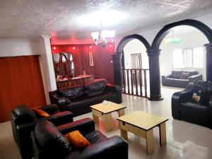 a living room with couches and chairs and a table at G Spot Hotel in Port Harcourt +5 photos