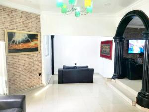 a living room with a couch and a chandelier at G Spot Hotel in Port Harcourt