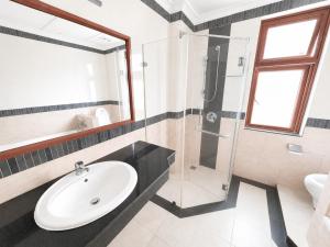 a bathroom with a sink and a glass shower at WH302 Residence by WH in Phnom Penh +8 photos