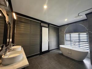 a bathroom with two sinks and two mirrors at Moma Paris Hotel Ninh Bình in Ninh Binh +24 photos