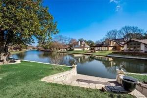 a river in a residential neighborhood with houses at Abundant Life in Arlington