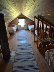 a attic room with two bunk beds and rugs at Villa Myklebostad in Sand