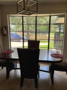 a dining room table with chairs and a large window at Abundant Life in Arlington