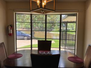 a dining room with a table and a large window at Abundant Life in Arlington