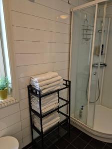 a bathroom with a rack of towels and a shower at Villa Myklebostad in Sand +70 photos