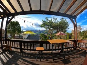 a table and chairs on a deck with a view at Morning Sound in Pyeongchang