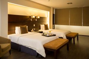 Rúm í herbergi á Unipark by Oro Verde Hotels