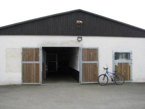 a bike parked in front of a garage at Reiterhof & Pension Lienemann in Grünbach
